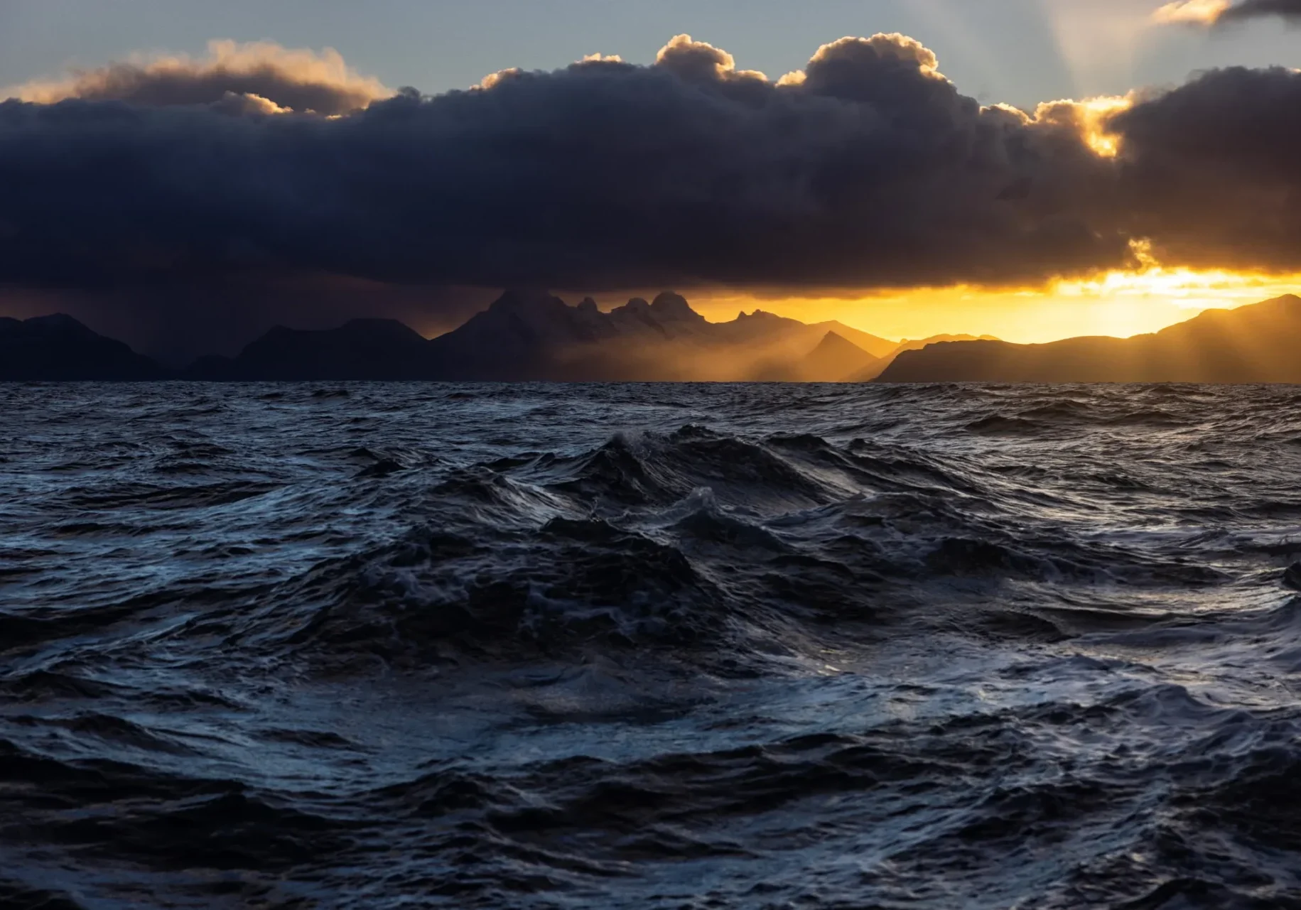Dramatic ocean waves at sunset